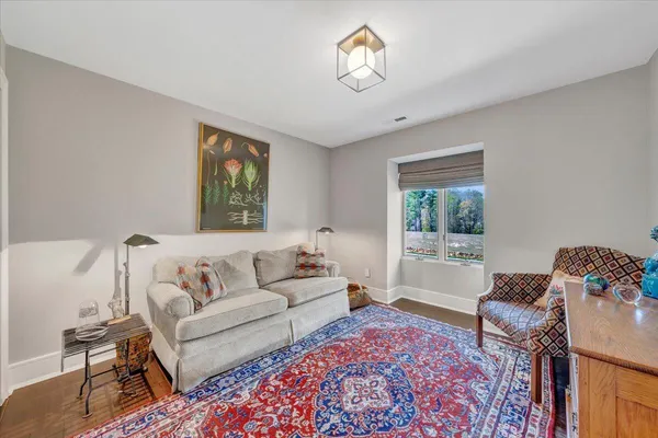a living room with furniture a rug and a flat screen tv