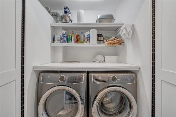 a workspace with furniture and a painting on the wall
