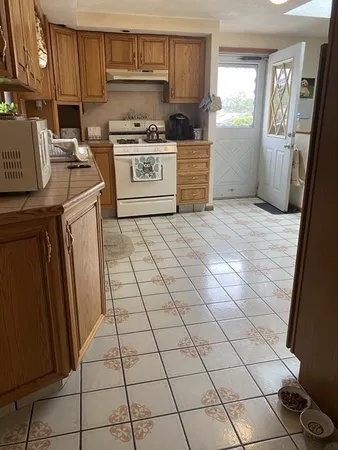 a kitchen with a stove a sink and a refrigerator