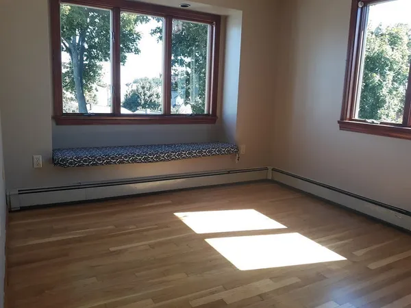 a view of a room with wooden floor and windows