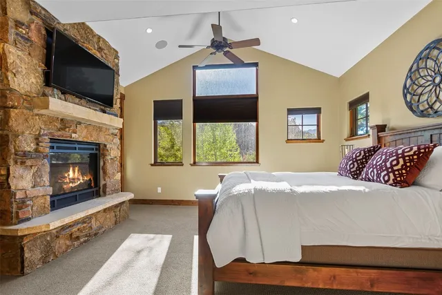 a bedroom with a bed and a fireplace