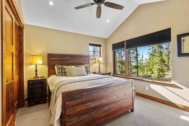 a bed sitting in a spacious bedroom next to a window