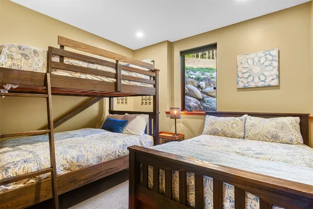 a bedroom with a bed and large window