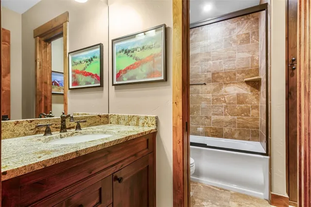 a bathroom with a granite countertop sink mirror and vanity
