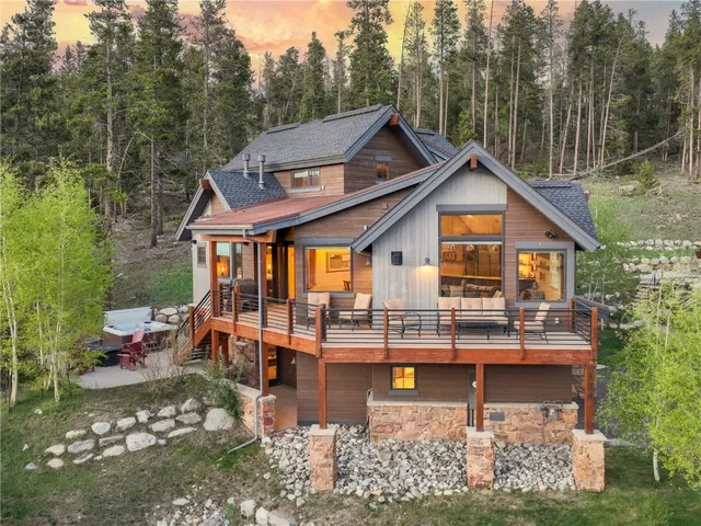 a view of a house with pool and chairs