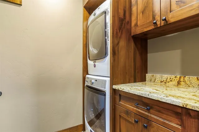 a bathroom with a granite countertop sink and white cabinets