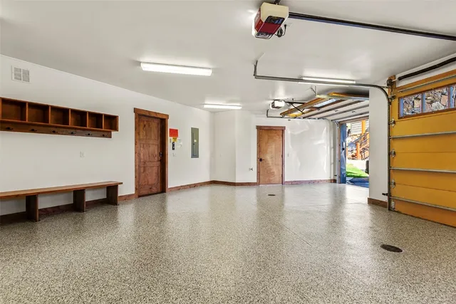 a view of a livingroom with wooden floor and ceiling fan