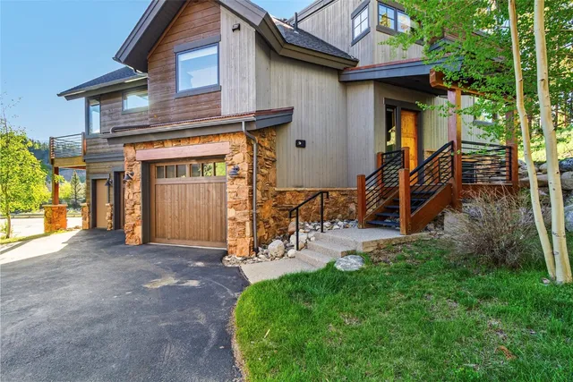 a view of a house with a yard and furniture