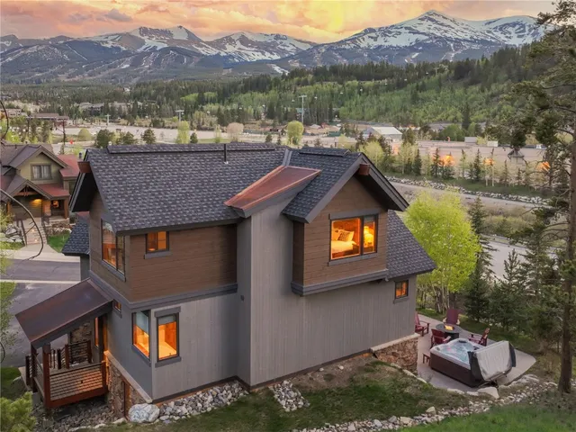 a aerial view of a house with swimming pool and a yard