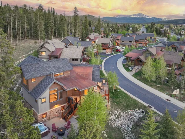 an aerial view of a house with a garden and lake view
