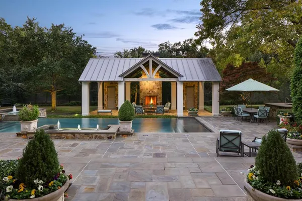 a view of a house with swimming pool and sitting area