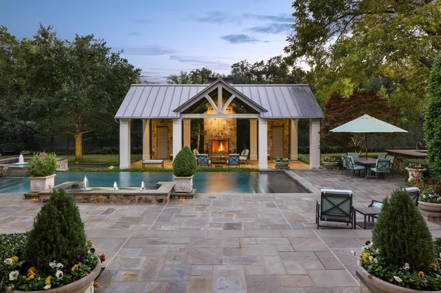 a view of a house with swimming pool and sitting area
