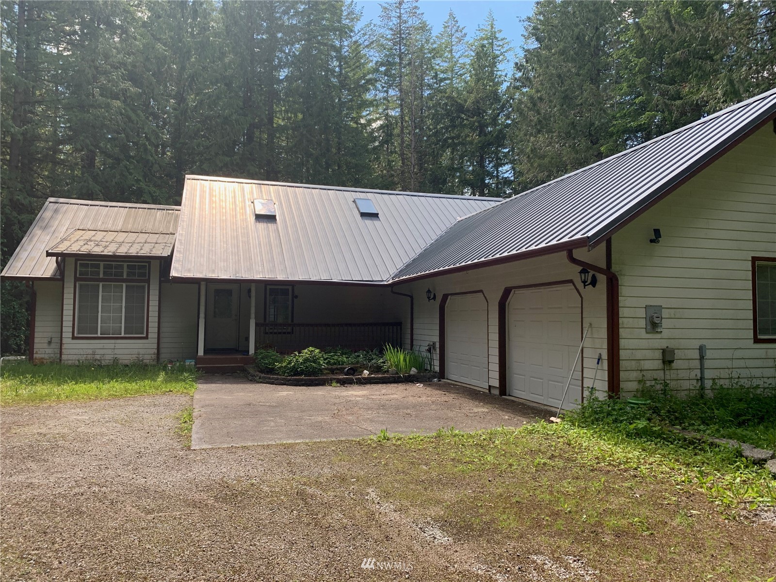 7711 Shire Road Maple Falls, WA 98266 - Photo 1 of 1 a view of a house with a yard and garage