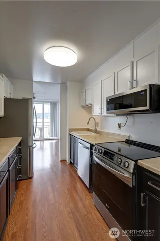 a kitchen with wooden floors and a sink