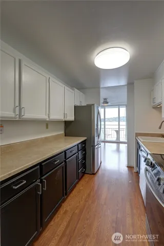 a utility room with wooden floor washer and dryer