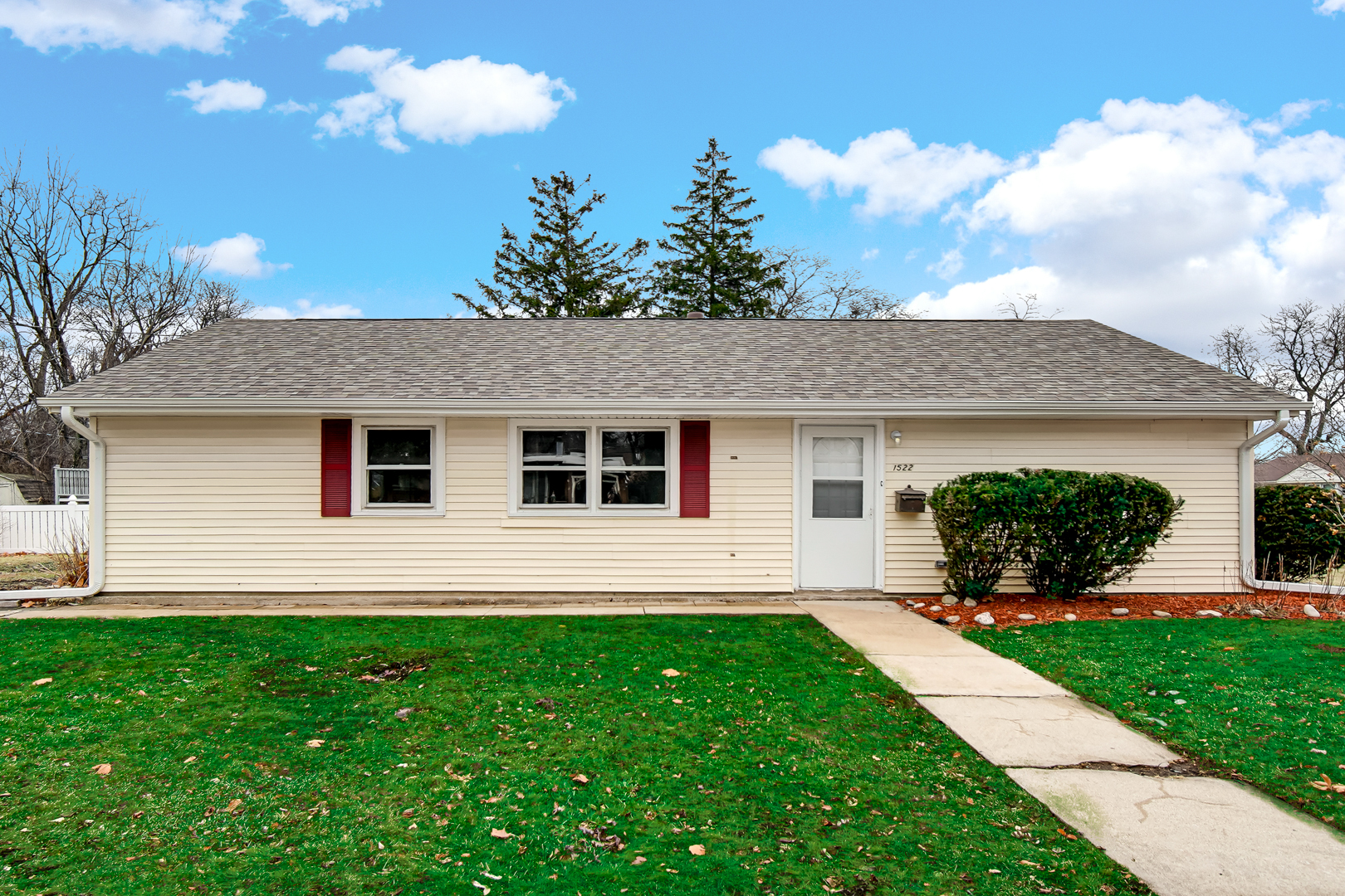 a front view of house with yard and green space