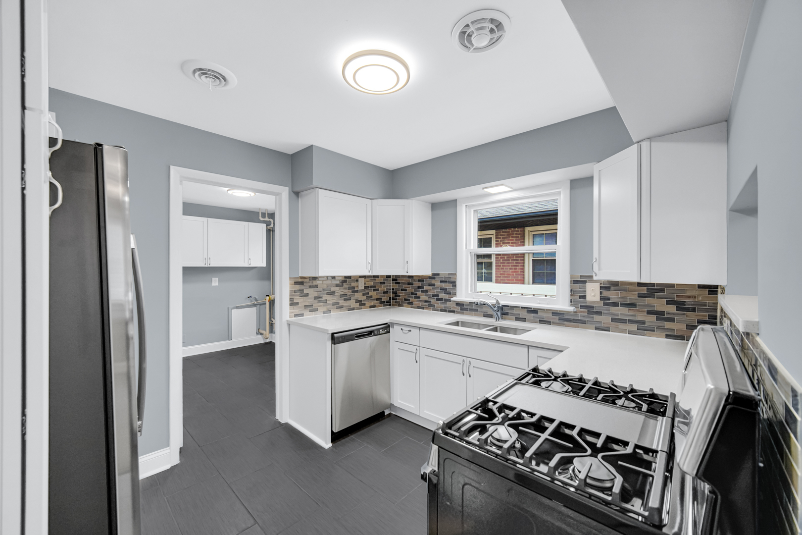 1522 186th Street Homewood, IL 60430 - Photo 11 of 22 a kitchen with a stove and white cabinets