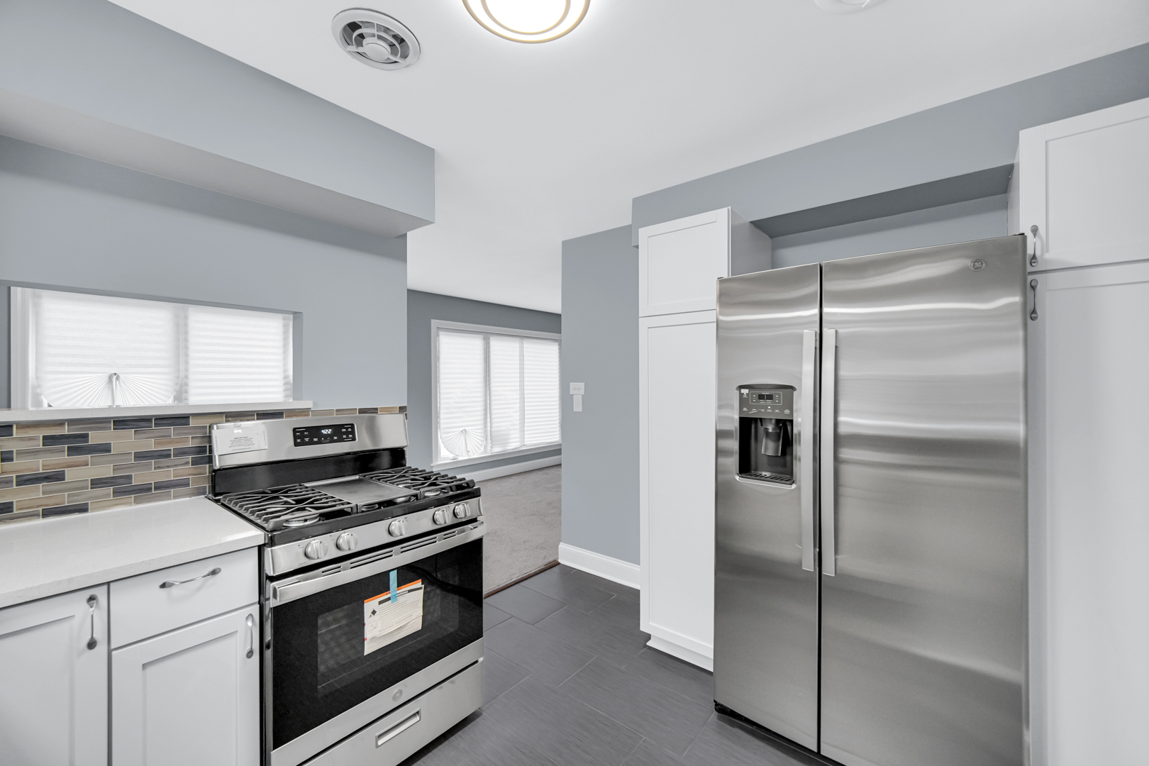 1522 186th Street Homewood, IL 60430 - Photo 14 of 22 a kitchen with a refrigerator a stove a washer and dryer