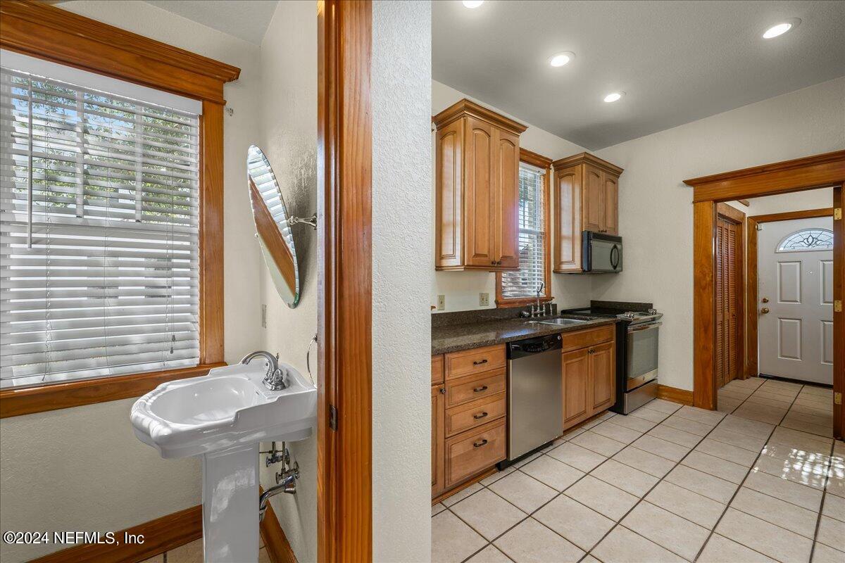 1954 Hubbard Street Jacksonville, FL 32206 - Photo 13 of 30 a spacious bathroom with a granite countertop sink and a mirror