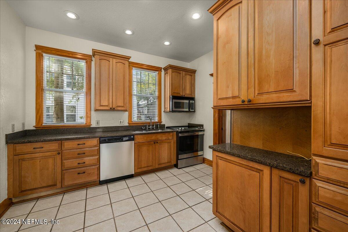 1954 Hubbard Street Jacksonville, FL 32206 - Photo 14 of 30 a kitchen with granite countertop a sink window and cabinets
