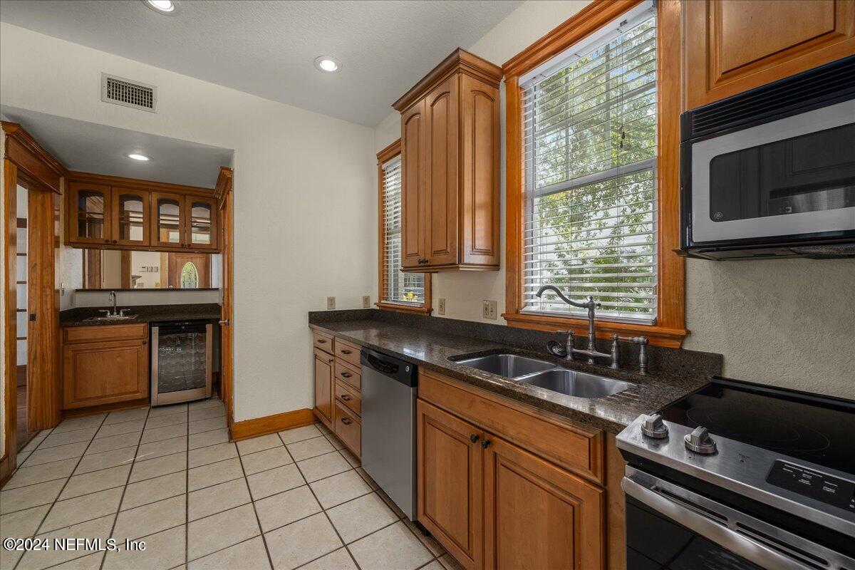 1954 Hubbard Street Jacksonville, FL 32206 - Photo 15 of 30 a kitchen with a sink a stove cabinets and a wooden floor