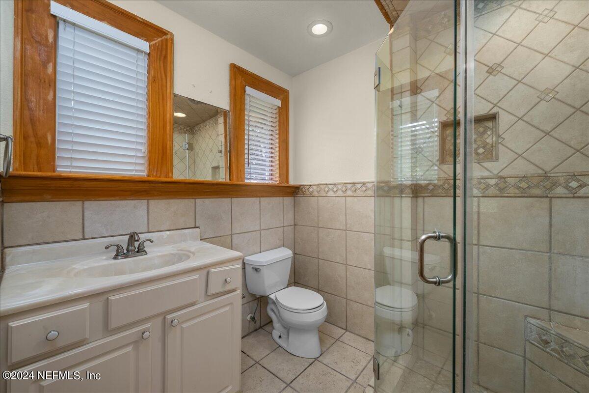 1954 Hubbard Street Jacksonville, FL 32206 - Photo 18 of 30 a bathroom with a toilet sink and mirror