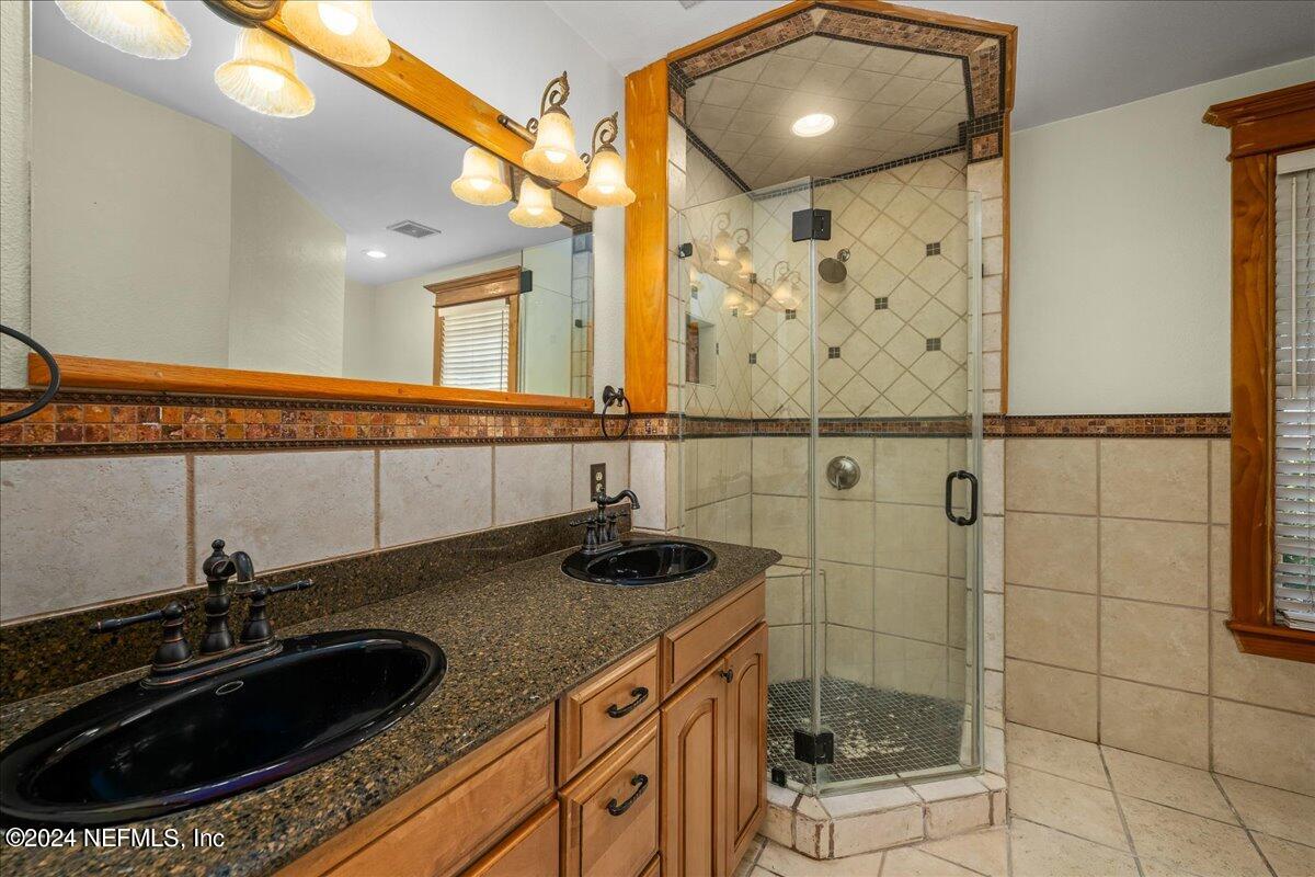 1954 Hubbard Street Jacksonville, FL 32206 - Photo 24 of 30 a bathroom with a sink a mirror and shower