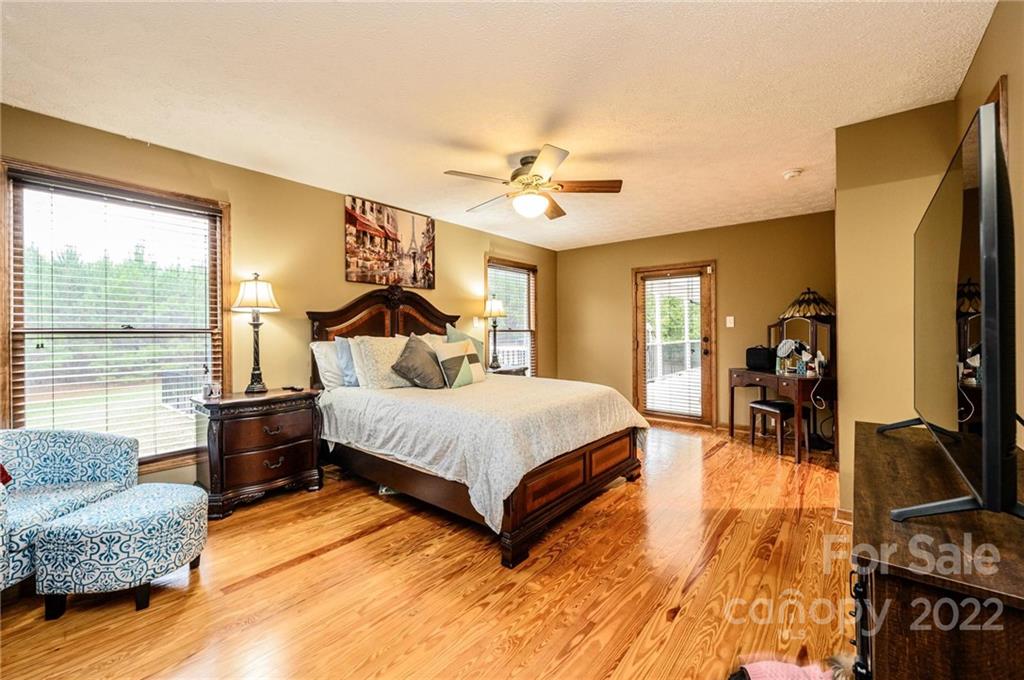 6265 Oxford School Road Claremont, NC 28610 - Photo 13 of 30 a spacious bedroom with a bed and wooden floor