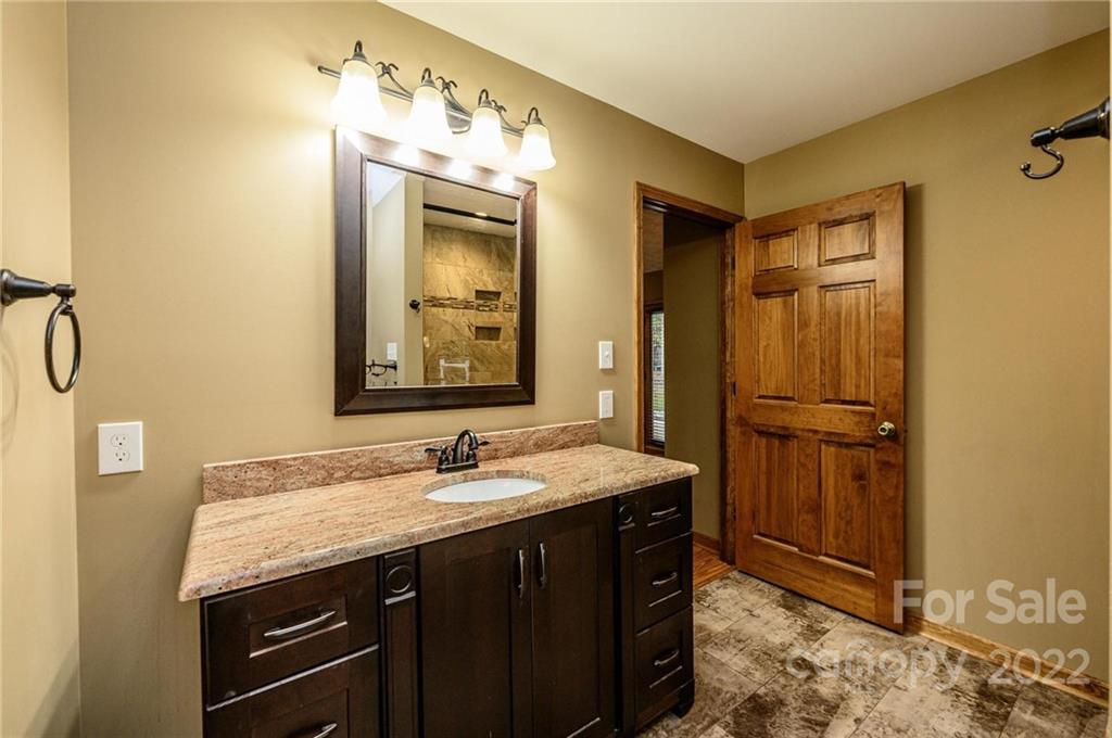 6265 Oxford School Road Claremont, NC 28610 - Photo 15 of 30 a bathroom with a granite countertop sink mirror and double