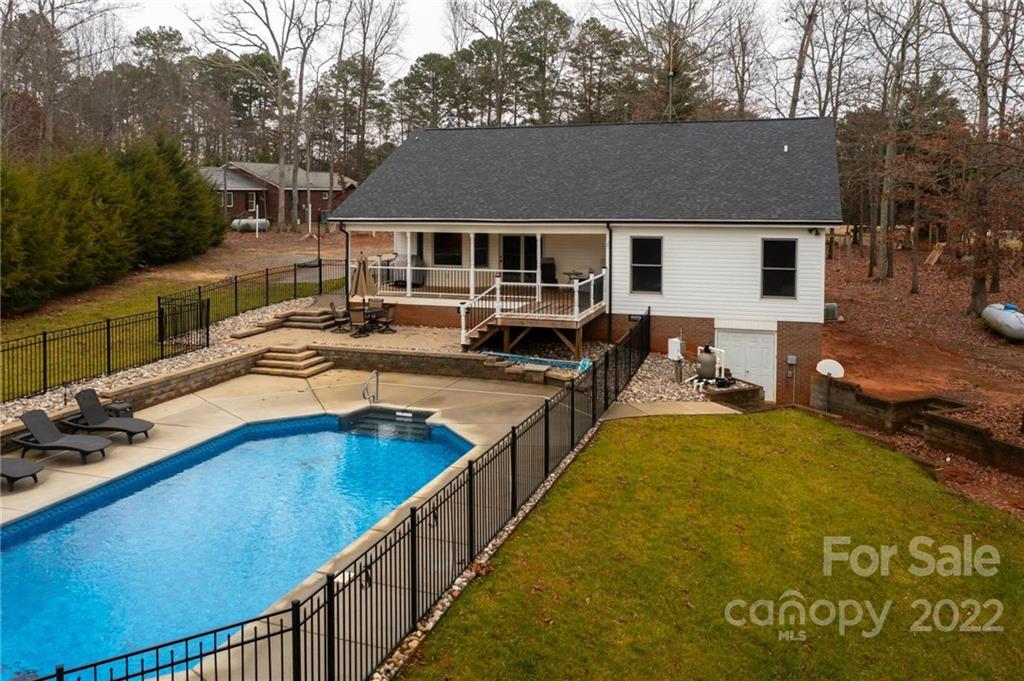 6265 Oxford School Road Claremont, NC 28610 - Photo 24 of 30 a view of a house with swimming pool and sitting area