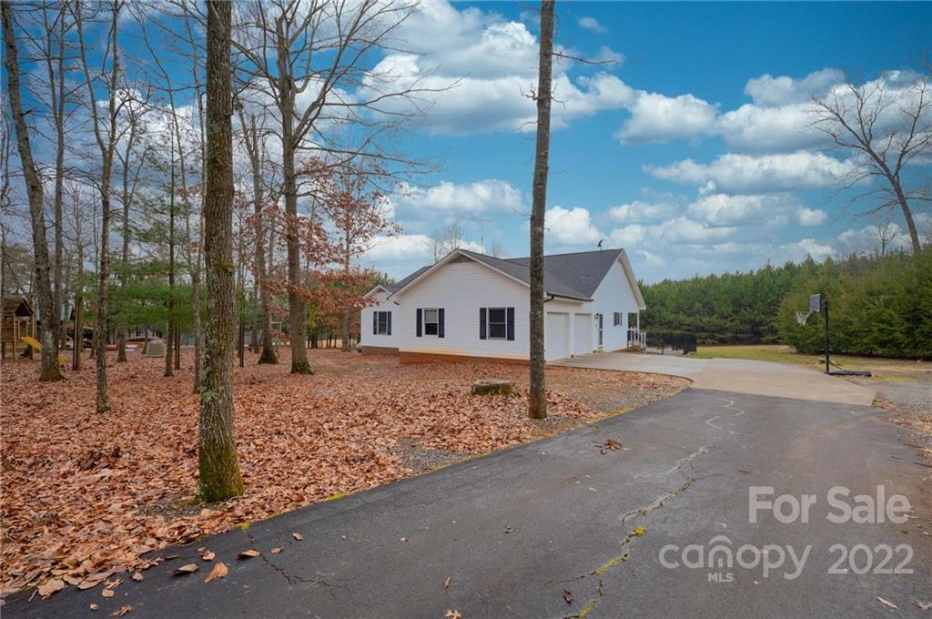 6265 Oxford School Road Claremont, NC 28610 - Photo 28 of 30 a white house that has tree in front of it