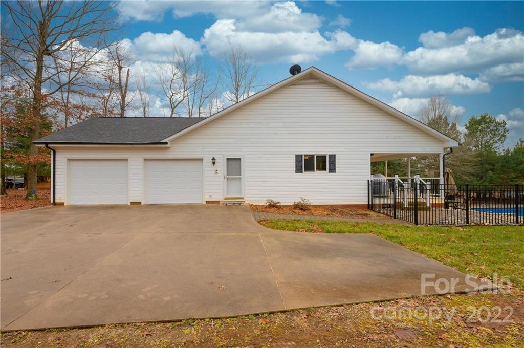 6265 Oxford School Road Claremont, NC 28610 - Photo 30 of 30 a view of a house with a yard and garage