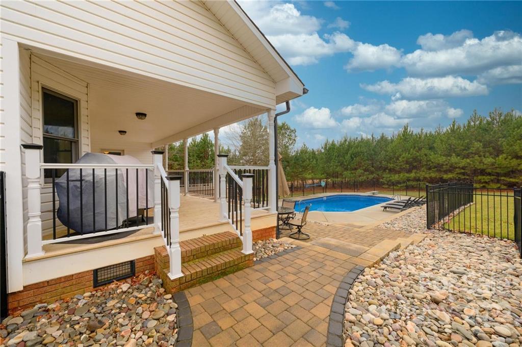 6265 Oxford School Road Claremont, NC 28610 - Photo 4 of 30 a view of a swimming pool with a lounge chair