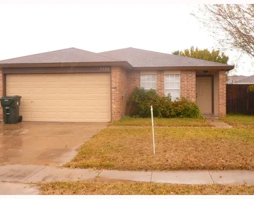 a view of a house with a wooden fence