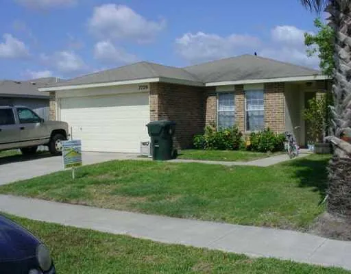 a front view of a house with a garden and yard