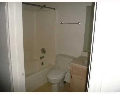 a bathroom with a toilet and shower