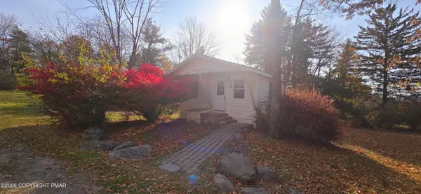 a view of a yard covered with snow in front of house