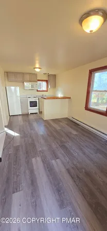 a view of a livingroom with wooden floor