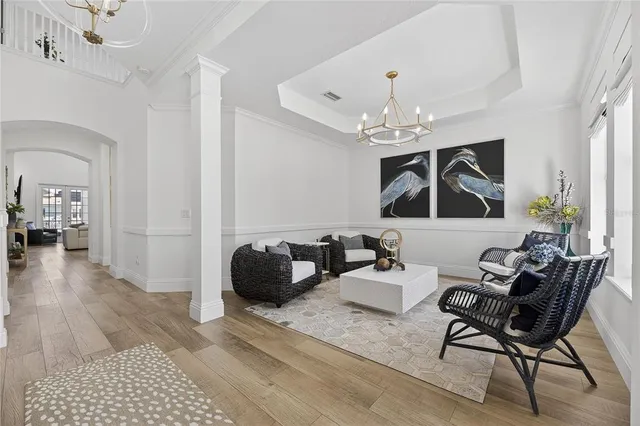 a living room with furniture and a chandelier