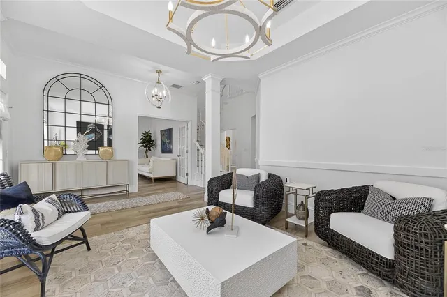 a kitchen with stainless steel appliances kitchen island granite countertop a refrigerator a stove a sink dishwasher and white cabinets with wooden floor