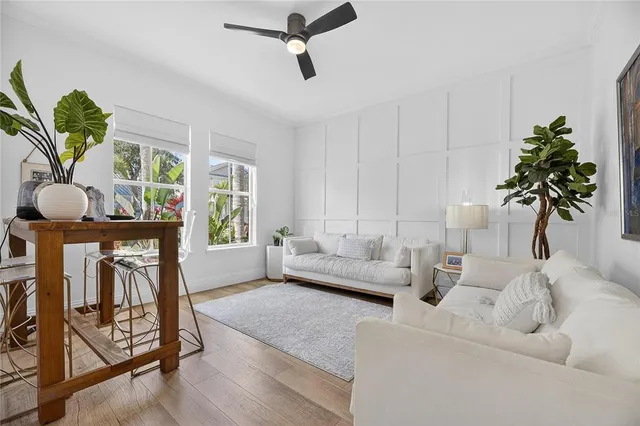 a kitchen with stainless steel appliances a table chairs and cabinets