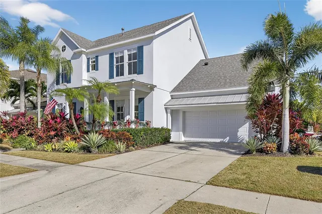 a front view of a house with a potted plant