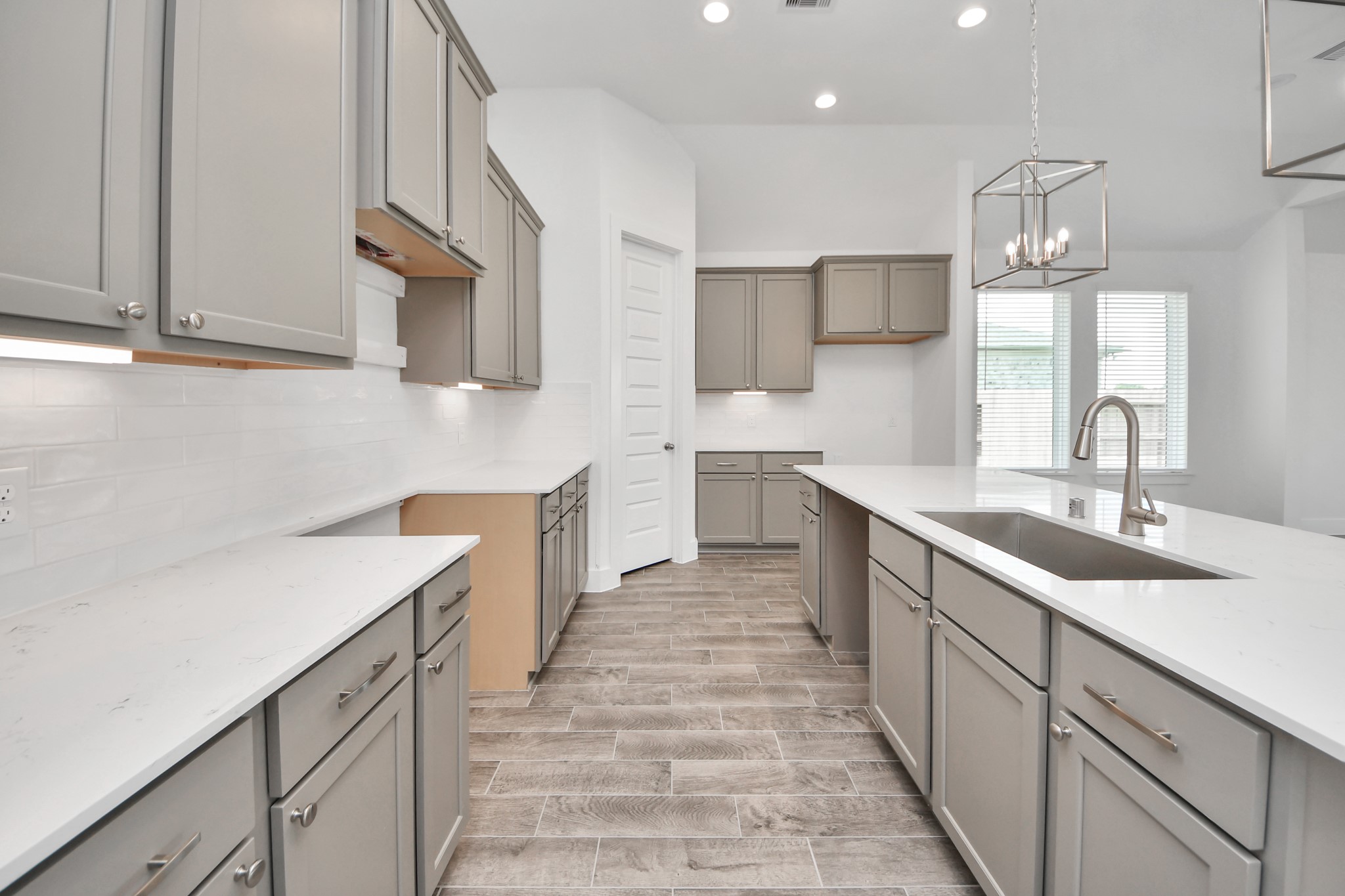3046 Native Spg Drive Spring, TX 77373 - Photo 12 of 35 The kitchen is a culinary haven, featuring granite countertops, a tile backsplash, stainless steel appliances, 42” upper cabinets, and undercabinet lighting. Sample photo of completed home with similar floor plan. Actual colors and selections may vary.