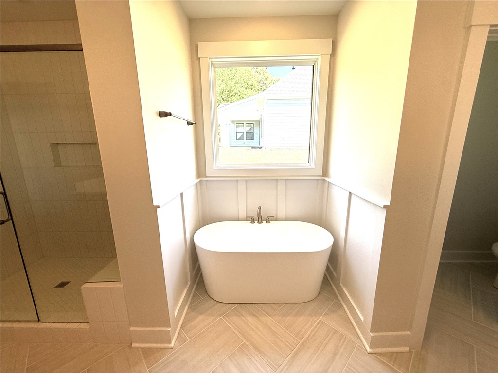 504 Tilman Court Anderson, SC 29621 - Photo 18 of 28 This spacious bathroom provides a serene retreat, complete with a freestanding soaking tub and ample natural light.