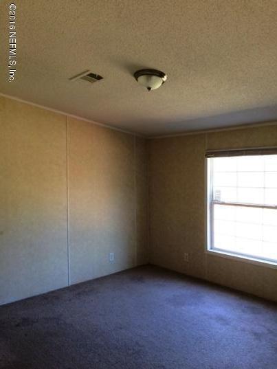 7820 Ranchette Road Keystone Heights, FL 32656 - Photo 13 of 19 an empty room with a window
