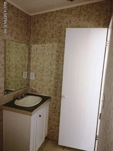 7820 Ranchette Road Keystone Heights, FL 32656 - Photo 15 of 19 a bathroom with a granite countertop sink and a mirror