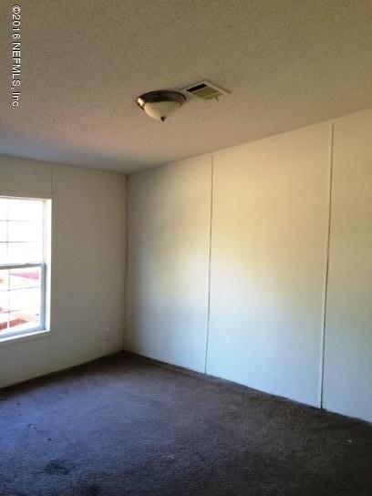 7820 Ranchette Road Keystone Heights, FL 32656 - Photo 16 of 19 an empty room with a ceiling fan and a window