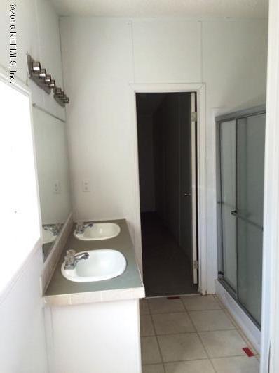 7820 Ranchette Road Keystone Heights, FL 32656 - Photo 9 of 19 a bathroom with a sink and a washing machine