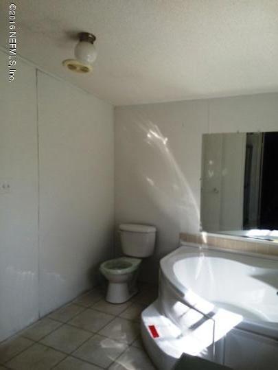 7820 Ranchette Road Keystone Heights, FL 32656 - Photo 10 of 19 a bathroom with a sink and a toilet