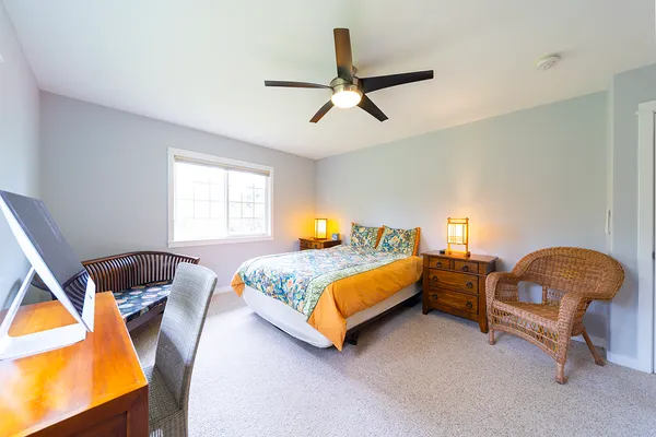 a bedroom with a bed chair and window